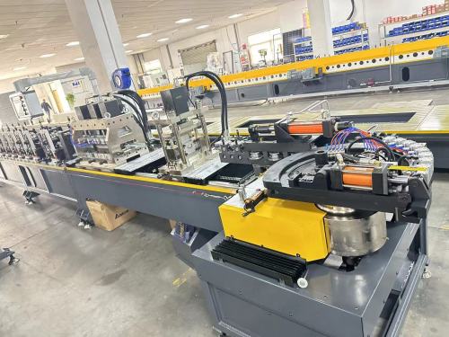 Sectional door track machine with automatic curve bending