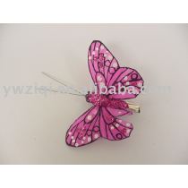Fine glitter powder spraying on craft butterfly