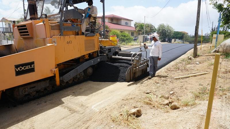 Road paving machine laying asphalt on street