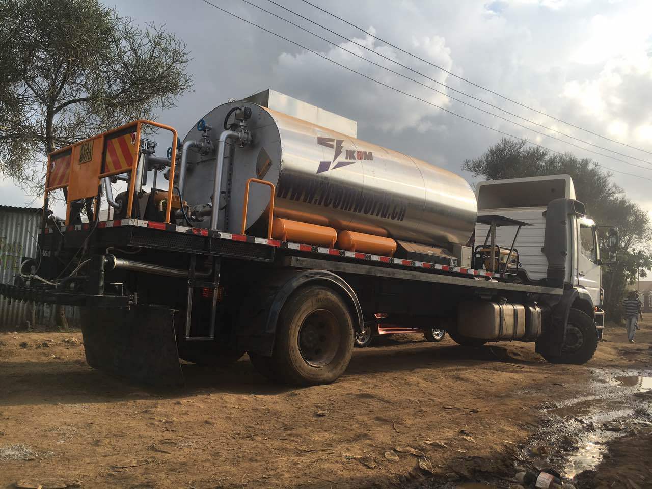 IKOM asphalt distributor truck spraying on a construction site in Kenya
