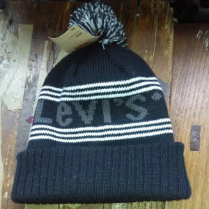 knitted pattern beanie hat with pompoms