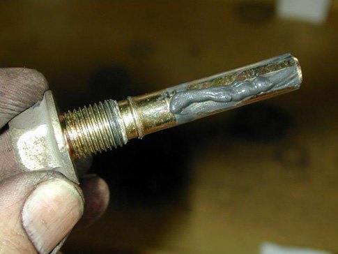 a clean caliper slider pin that's been coated with fresh brake lubricant – an essential step of any brake job