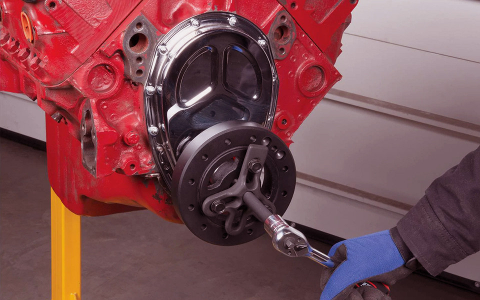 bearing puller removing wheel bearing and harmonic balancer in automotive workshop