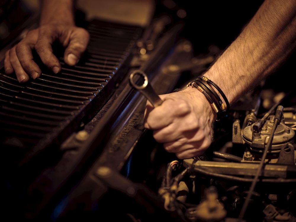 Technician using a hand tool during vehicle service