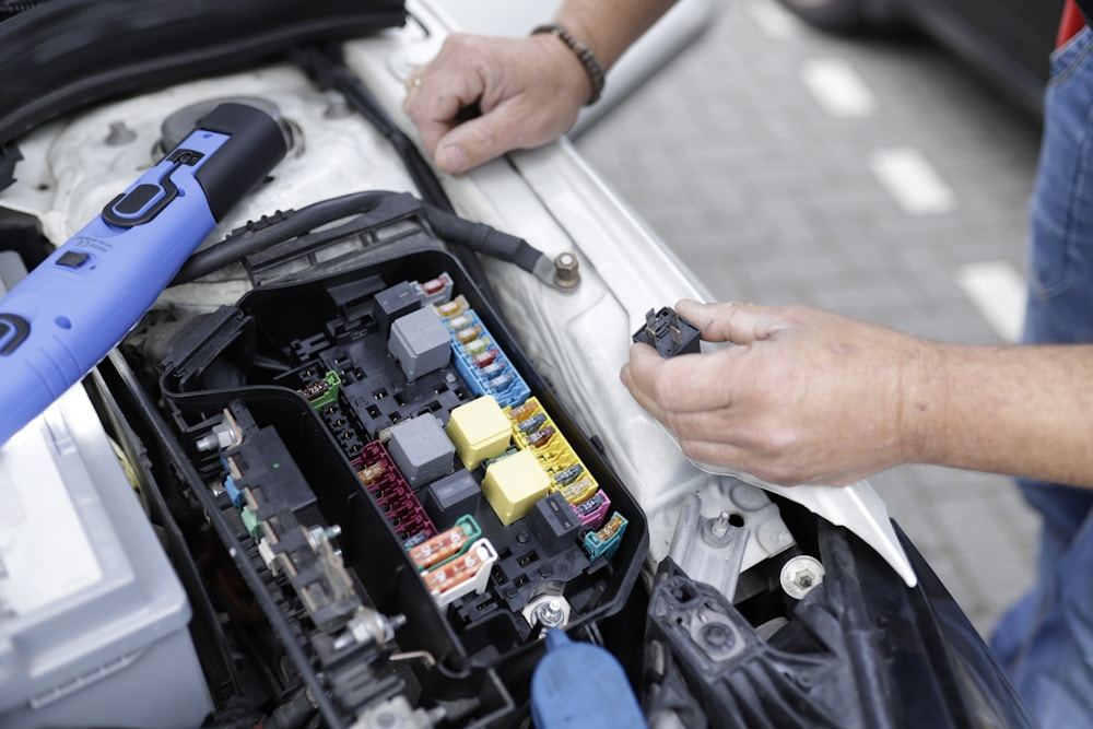 Technician working carefully around a vehicle component