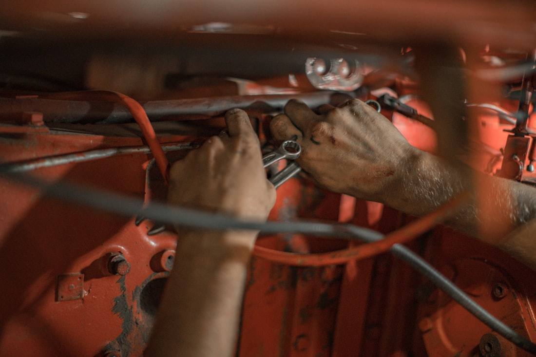 Technician using hand tools during a controlled mechanical repair