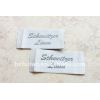 white ground with grey logo satin woven labels