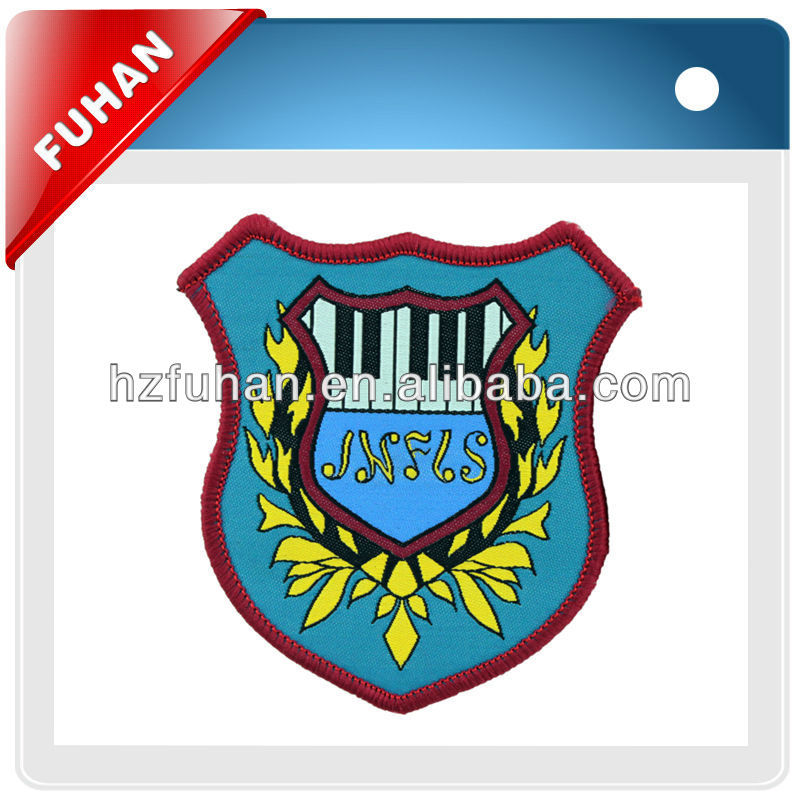 Bordered woven patch with adhesive back