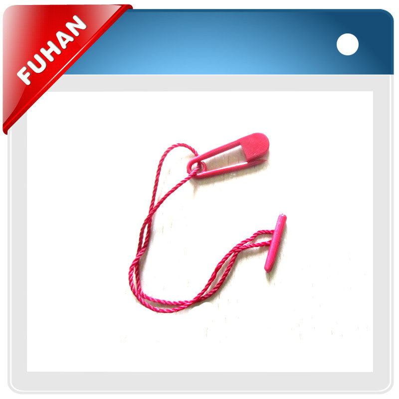 Garment string seal tag with safety pin