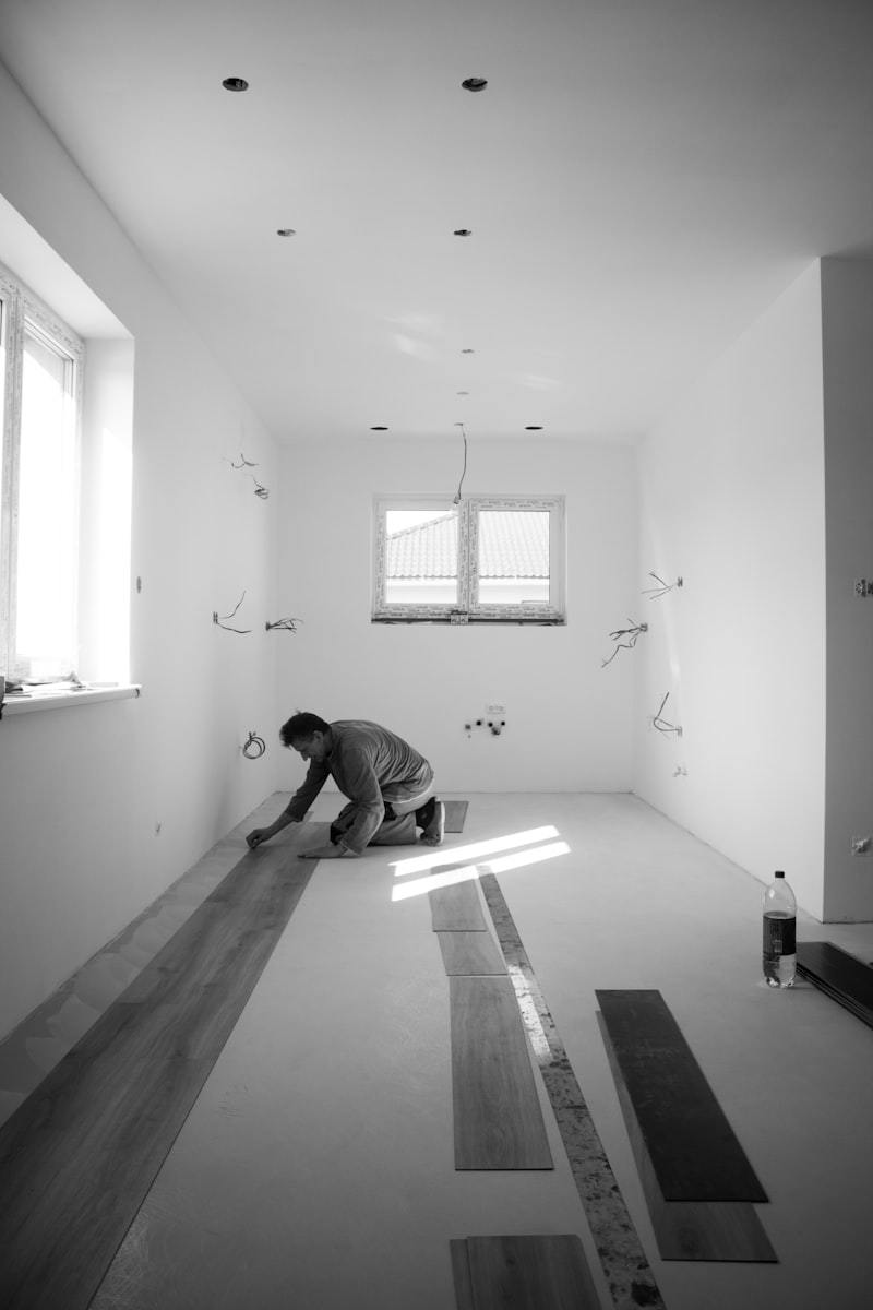Professional flooring installation showing vinyl plank being laid in a modern home interior