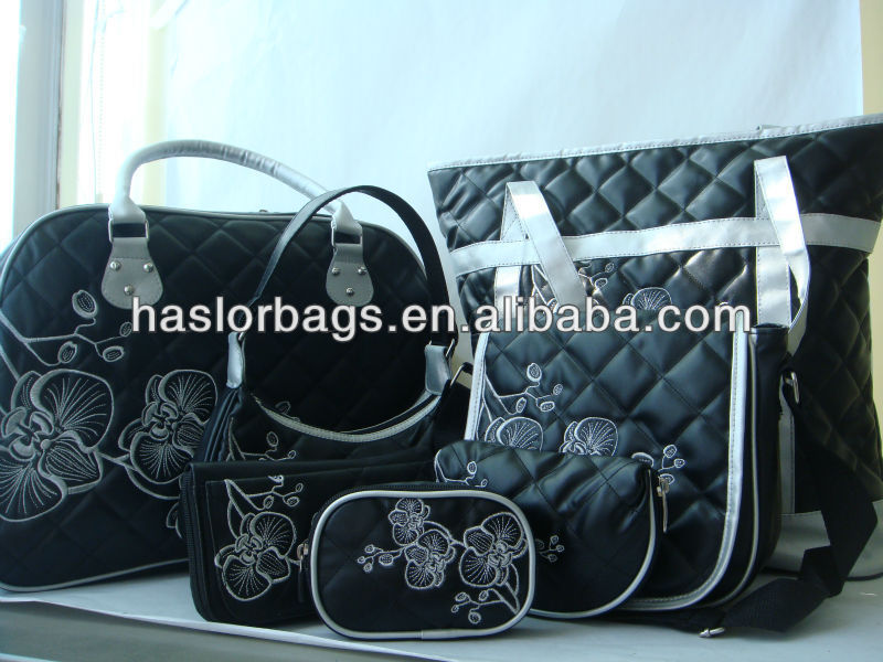handbags with flower on front of handbag