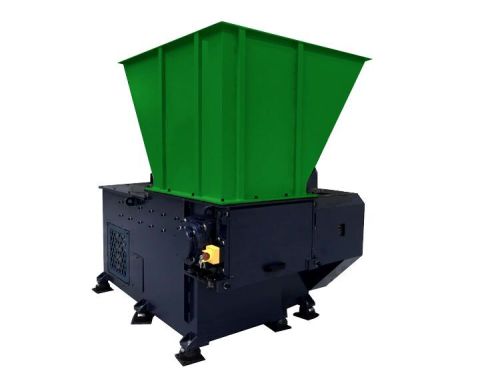 Industrial single shaft shredder machine for recycling applications.