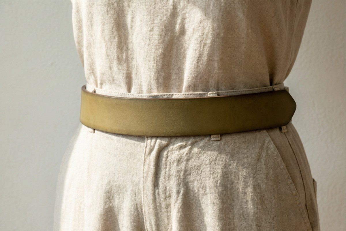 Minimalist leather belt styled with neutral earth-tone outfit