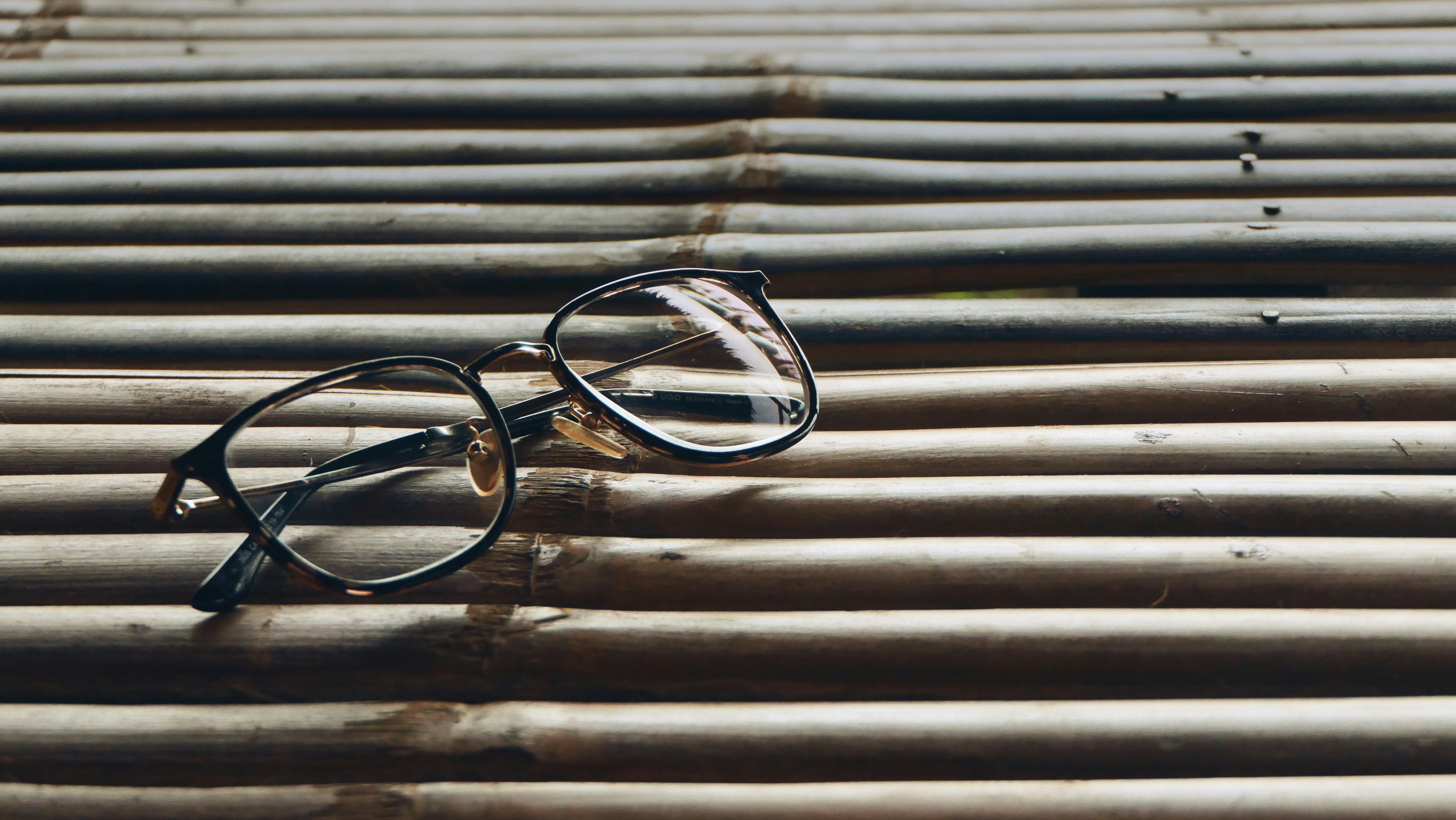 Close-up of a child's eyeglass frames with beautiful bamboo temples, highlighting the natural grain.