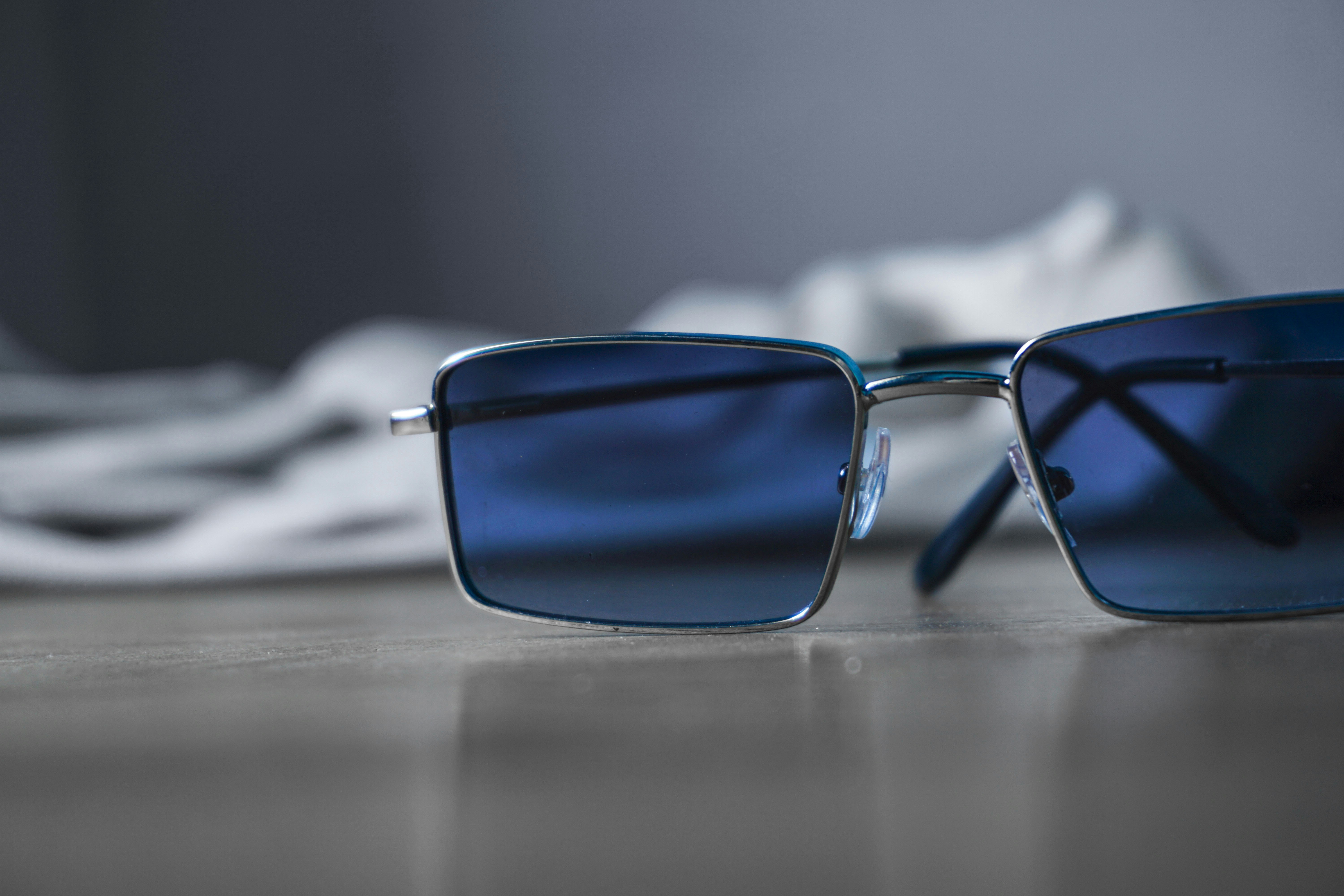 A collection of thin and square metal frame sunglasses in various finishes.