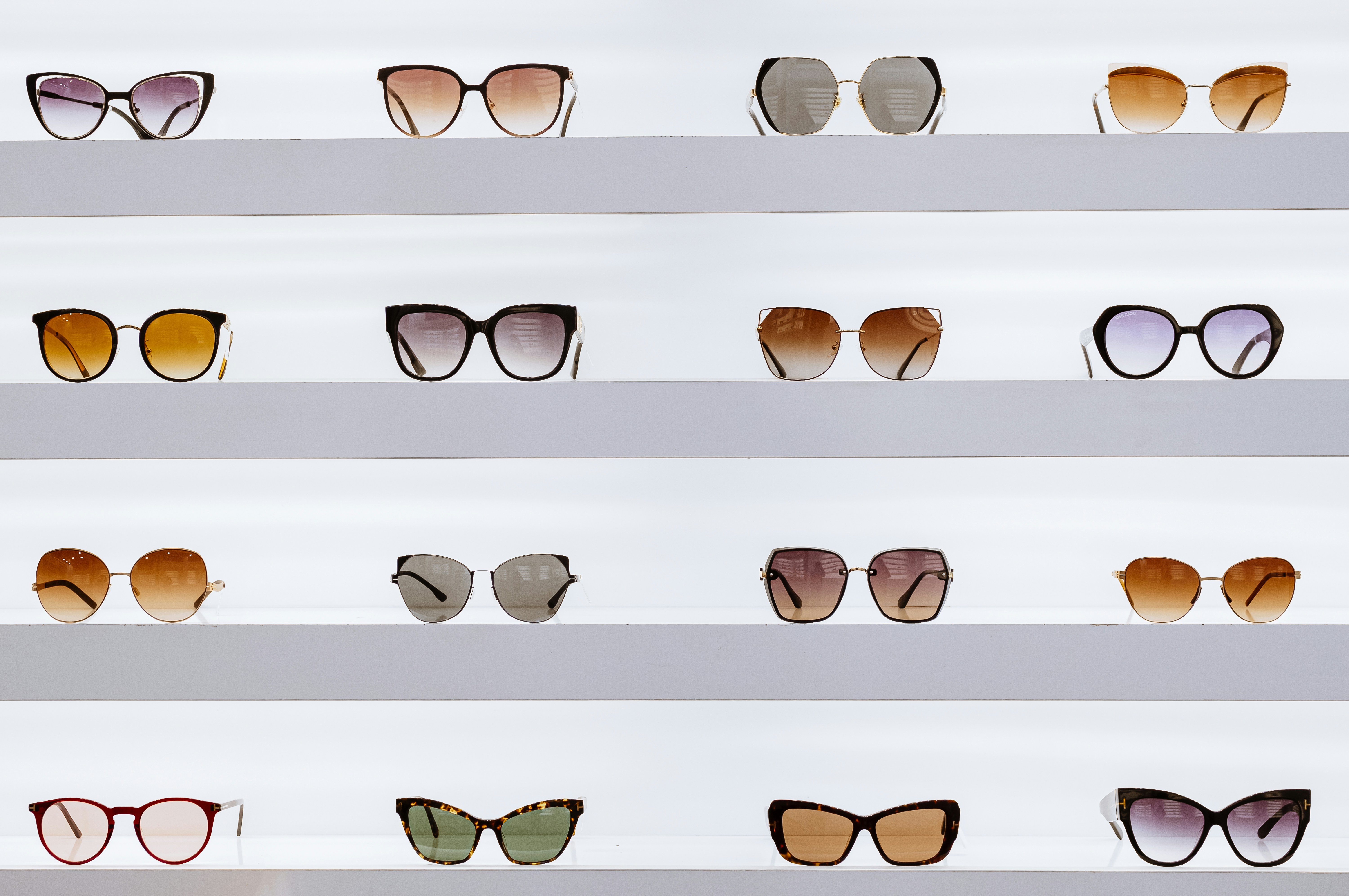 A collection of different sunglasses styles including fashion, sports, and geometric frames