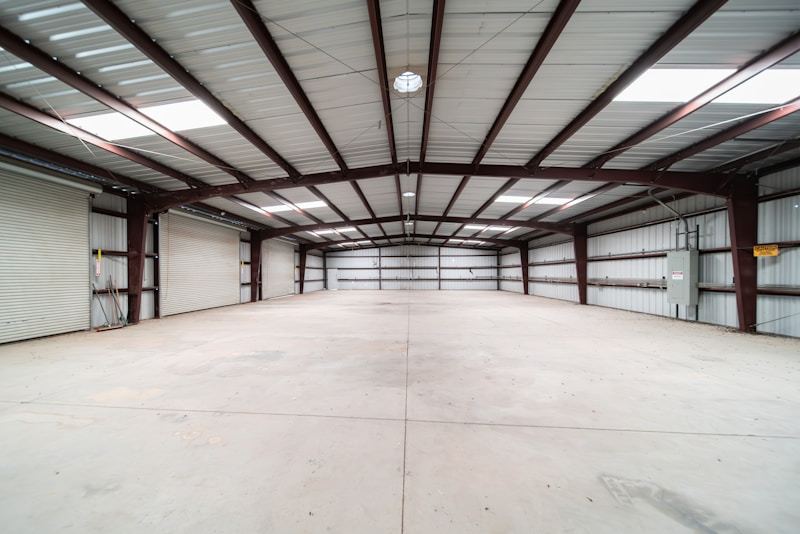 Interior of large steel warehouse with shelving