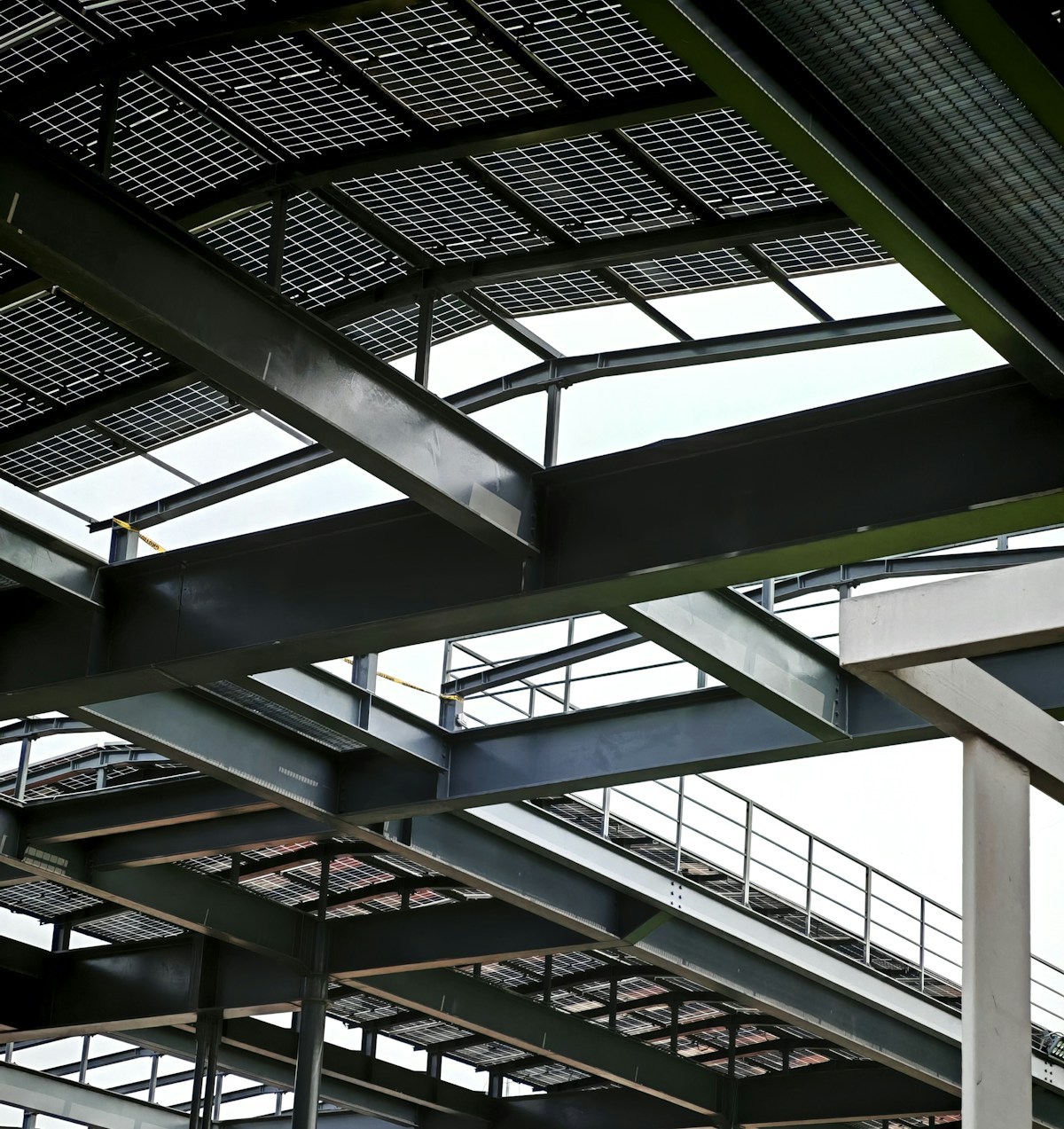 Steel frame warehouse construction with beams and roof installation