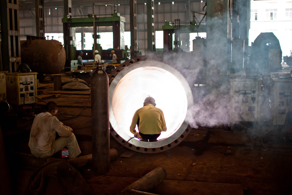 Welder working with steel in a fabrication workshop