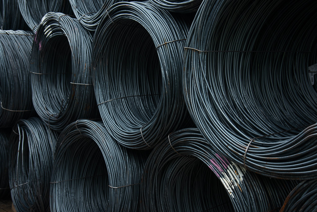 Steel wire rod being drawn through dies in a wire mill