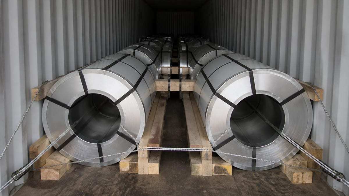 Packaged PPGI coils secured with timber blocking dunnage and lashings inside a container