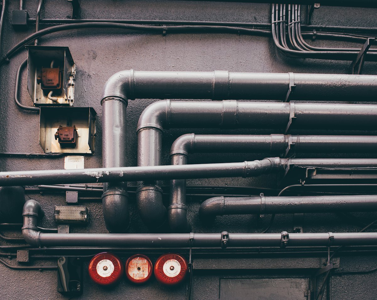 Industrial metal piping network showing pipe used as part of a service system