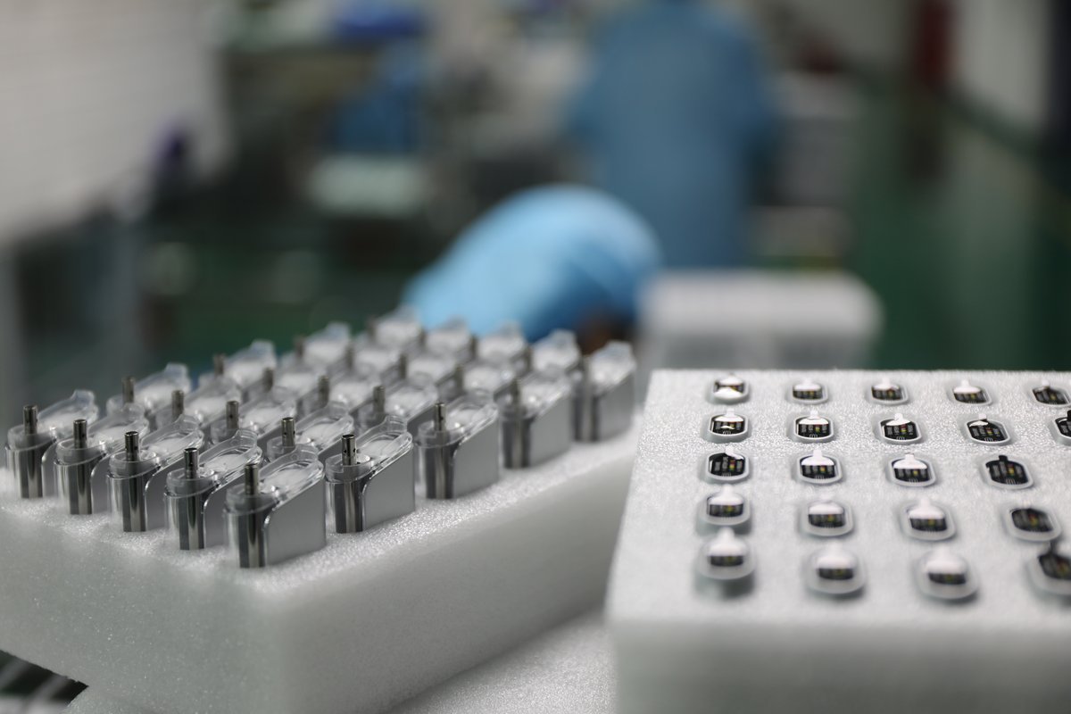 Vape cartridges arranged in production trays for quality control