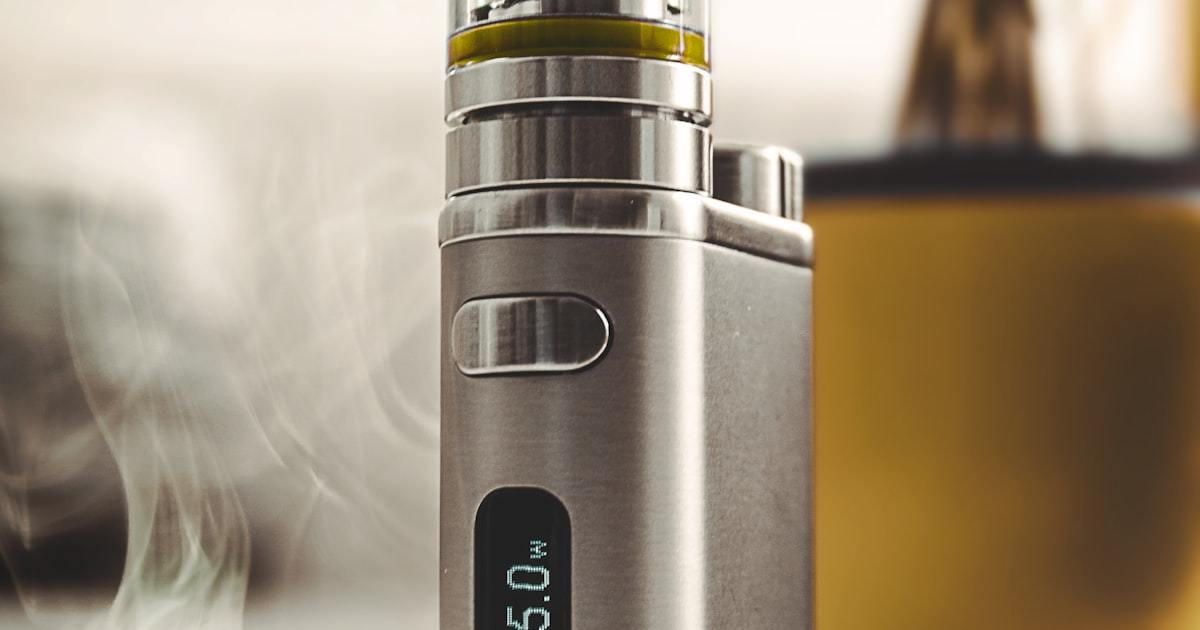 Compact gray vape device on a clean light background, inspected during field return analysis