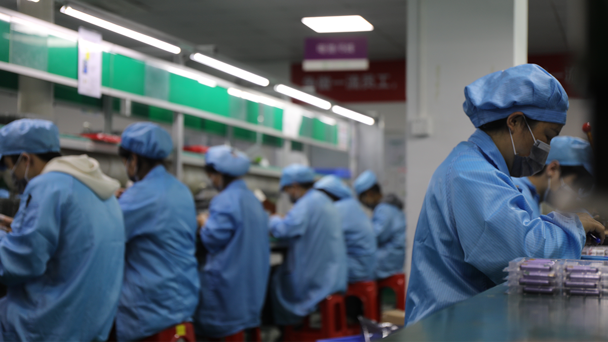 Modern vape hardware manufacturing facility with clean production lines, automated assembly machines, and quality control stations