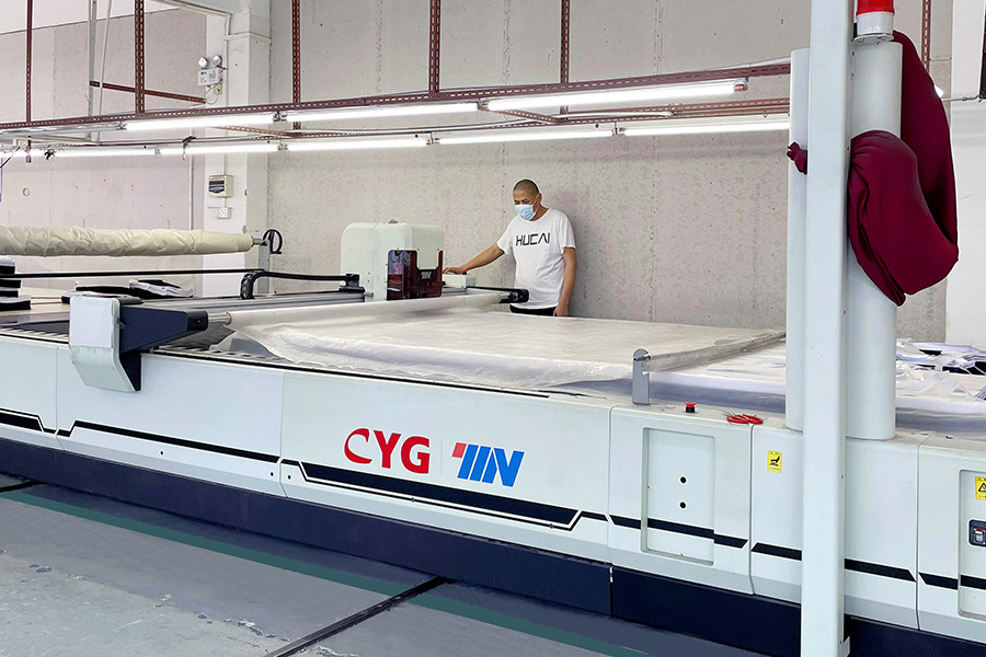 Automated fabric cutting machine in the HUCAI cutting room