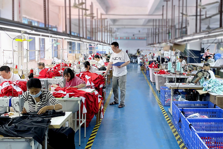 HUCAI sewing floor: operators stitching activewear at workstations