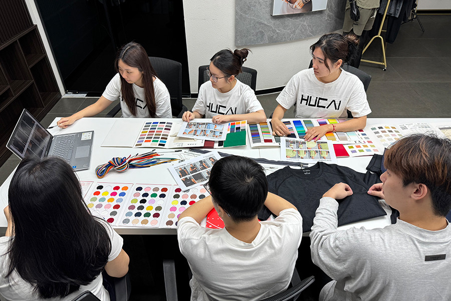 HUCAI sampling review with fabric swatches and colour references laid out on the table