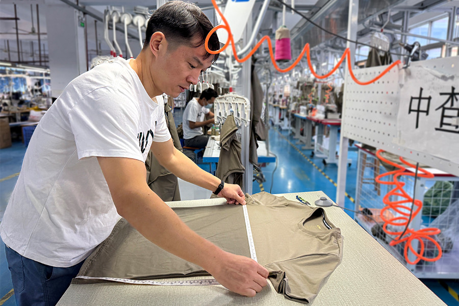 In-line quality inspection at HUCAI: measuring a finished garment against the spec sheet