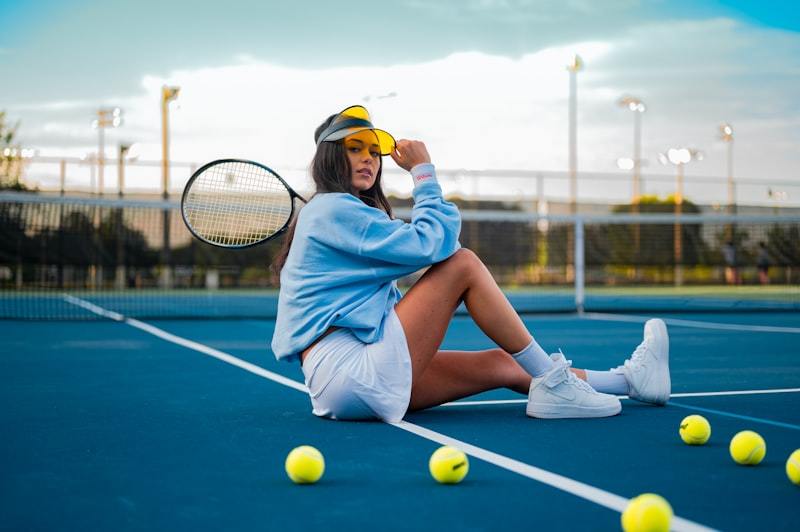 Women's tennis player in performance activewear on court