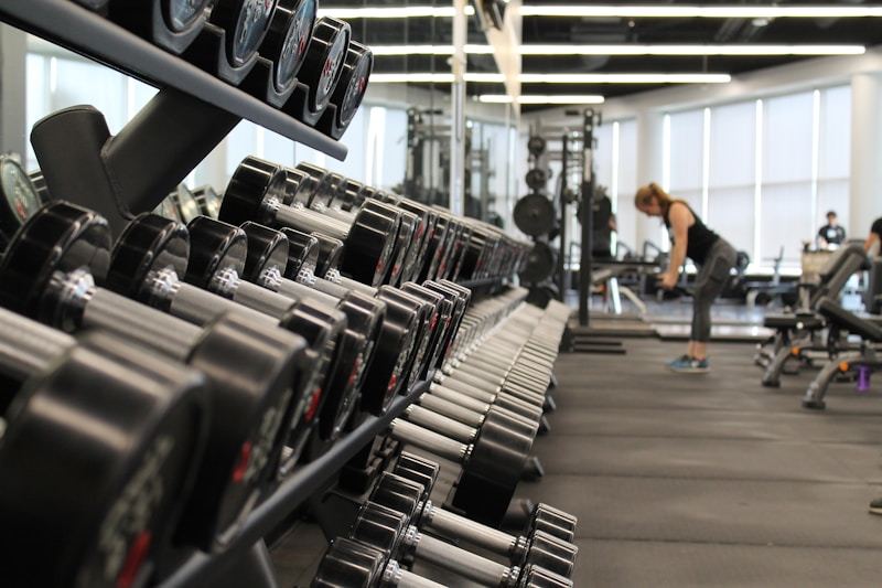 Man in gym performing strength training wearing quarter-zip athletic top
