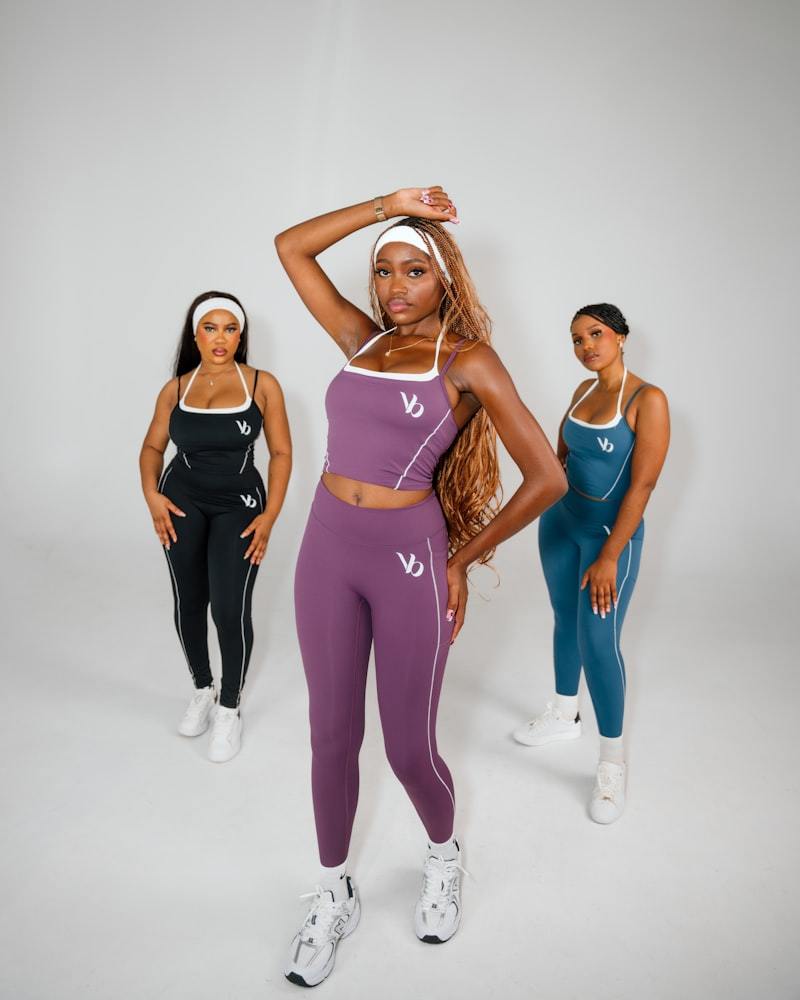 Three women in athletic wear posing together