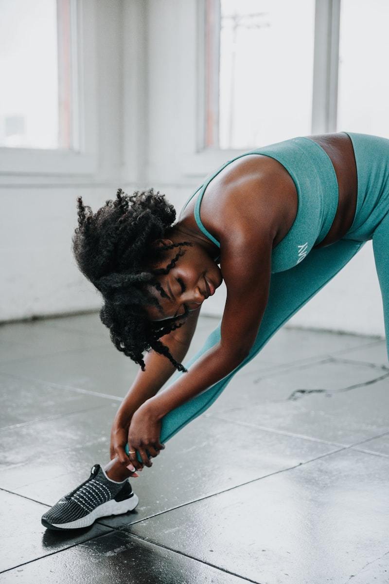 Woman in activewear doing a yoga pose on a mat