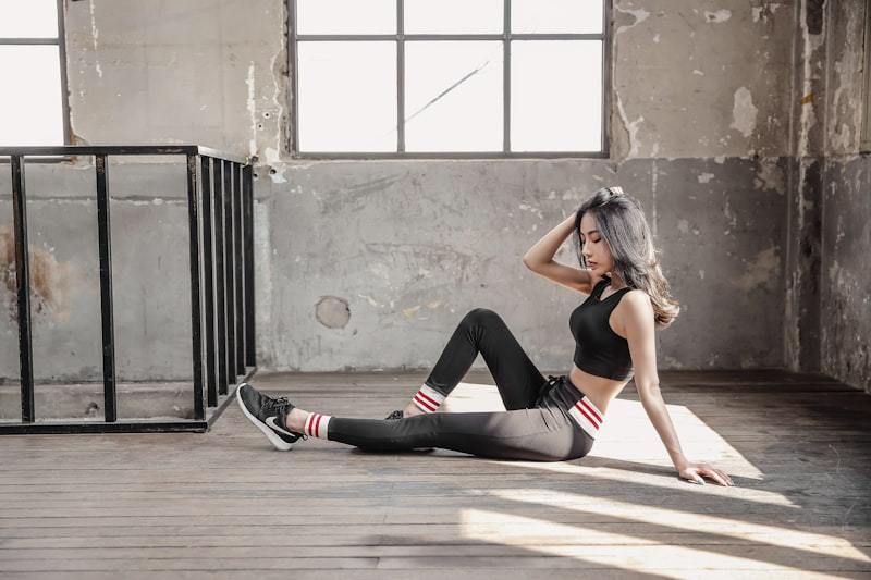 Woman in black leggings practicing yoga on a mat
