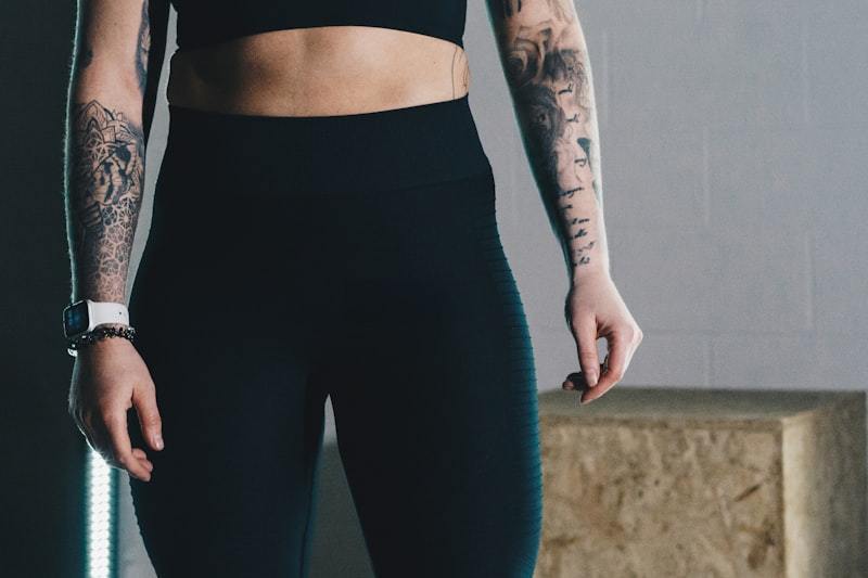 Woman in a black sports bra and leggings in an activewear studio