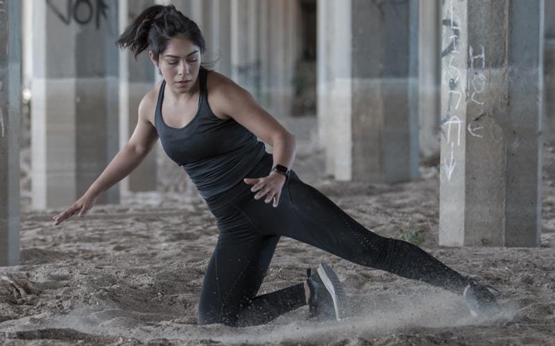 woman in a tank top and leggings practicing yoga, showing movement fitting and ease zone review