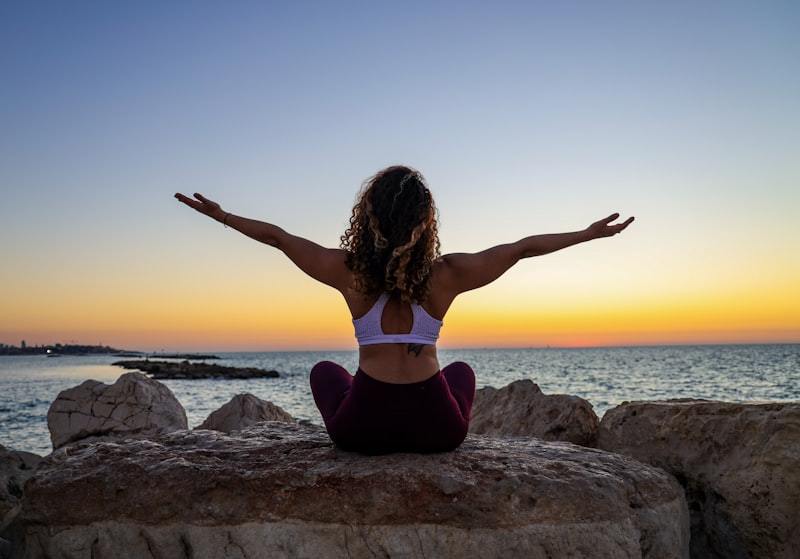 woman sitting in a yoga position outdoors, representing fit review across movement and sample evaluation