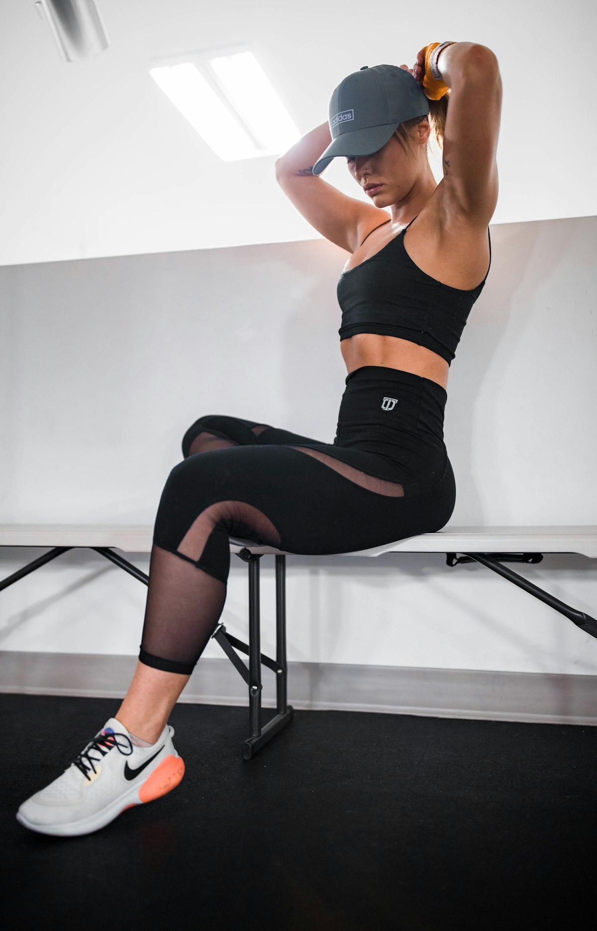 woman doing yoga in a black sports bra and black leggings