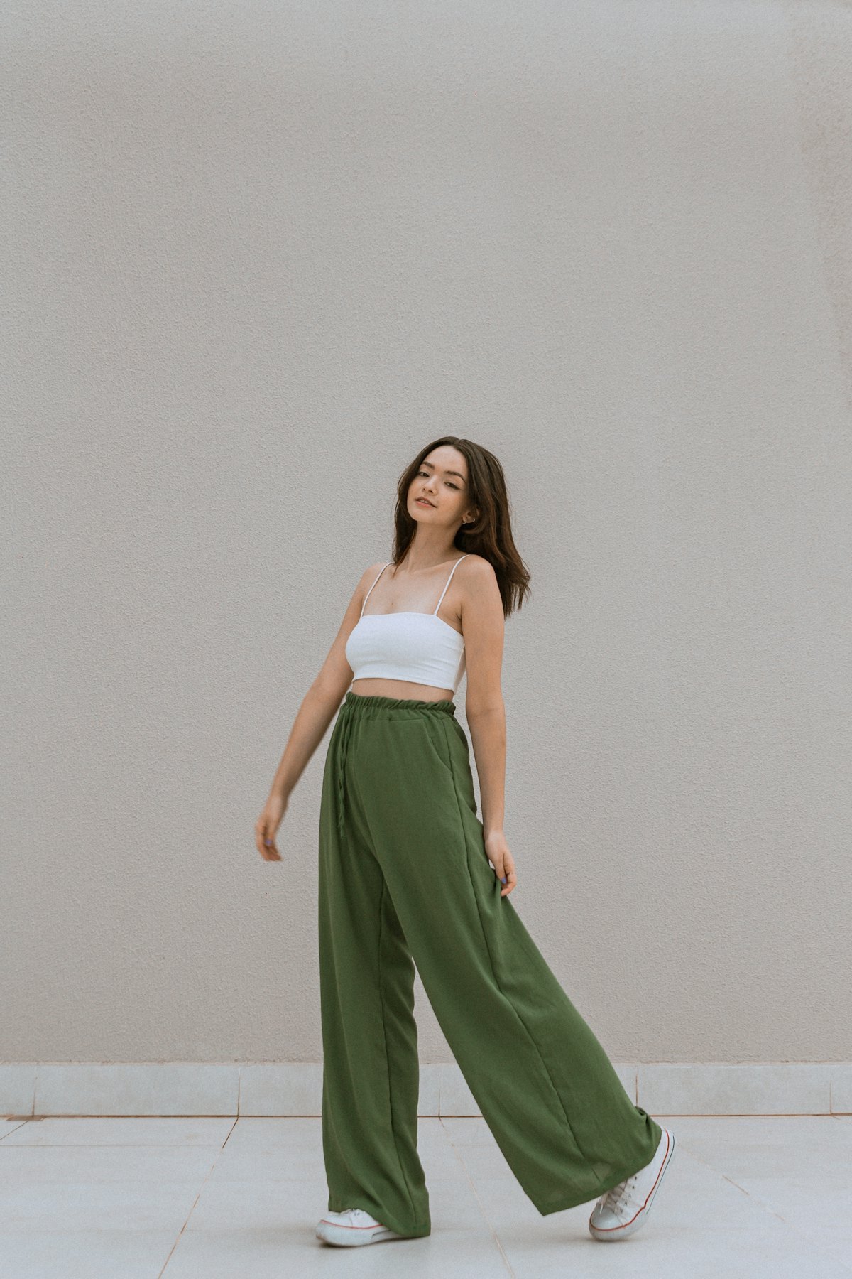 woman wearing high-waisted wide-leg pants in a relaxed everyday activewear look