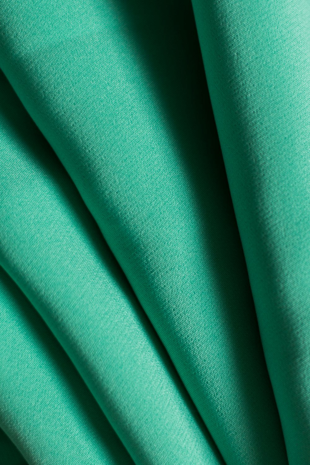 draped teal fabric with soft vertical folds used for activewear bottom development review