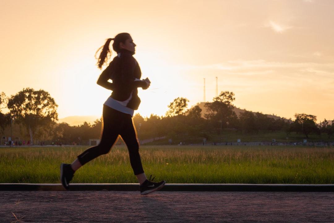 woman running outdoors wearing a lightweight performance training top