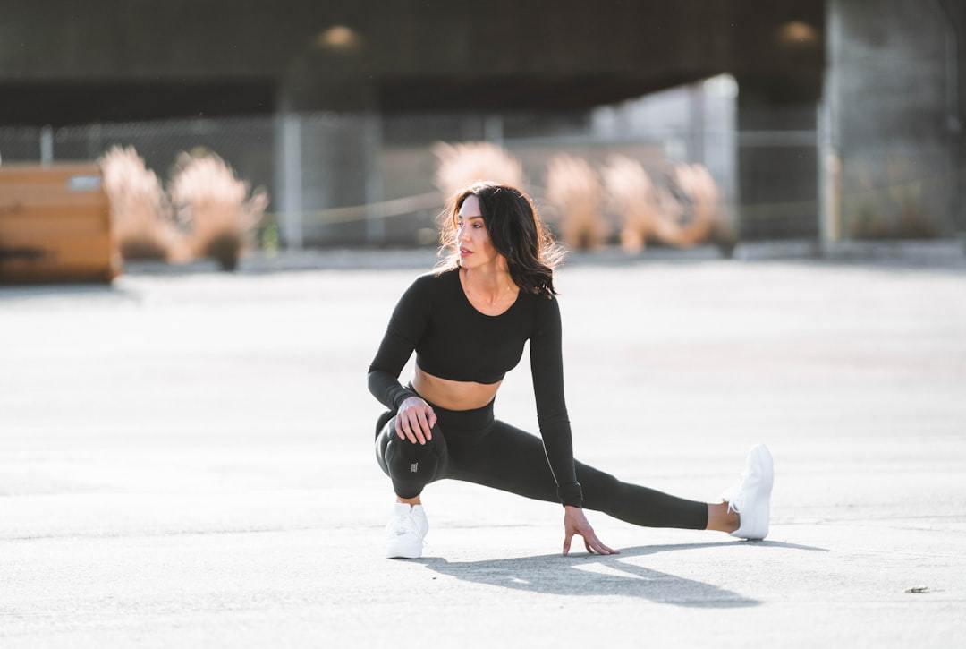 woman wearing a black training tank top and leggings before a workout