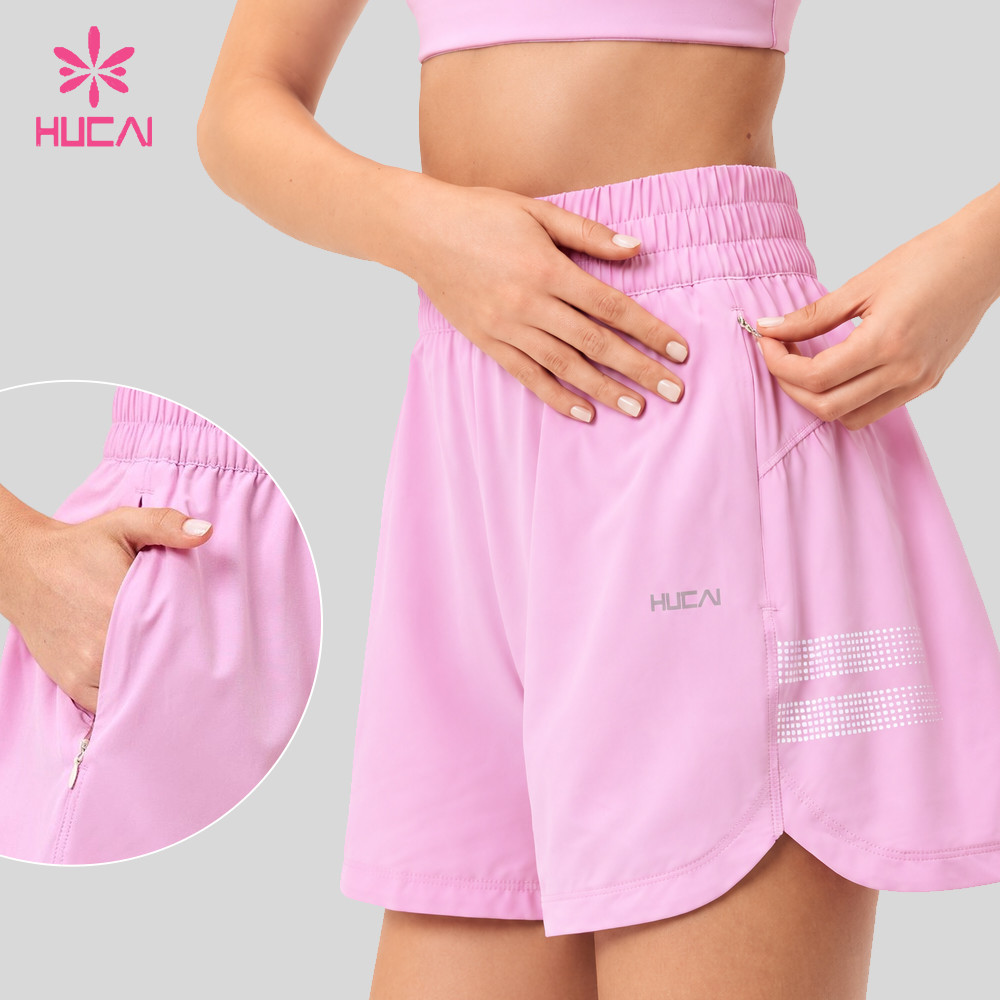 Concealed zip pocket set into the side seam of the pink shorts