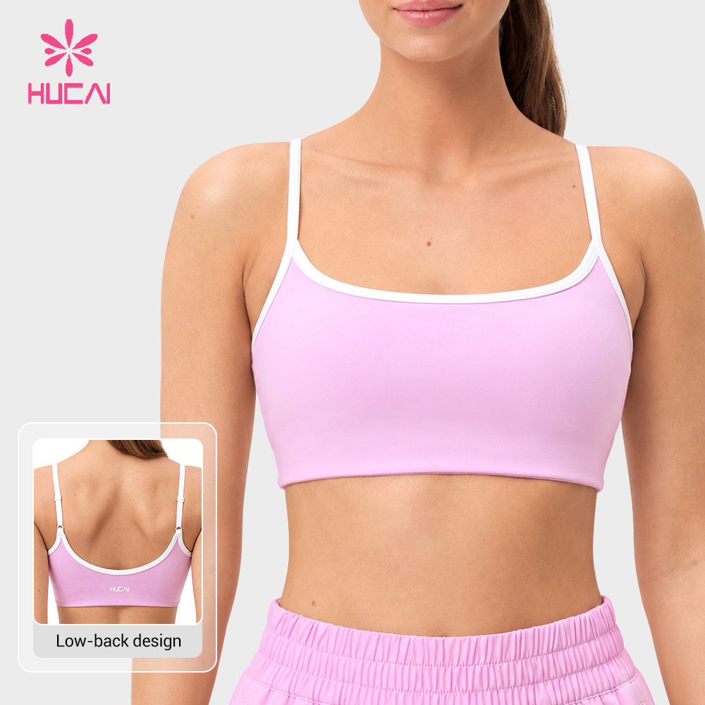 Custom light pink sports bra front view showing the wide neckline and contrast edging