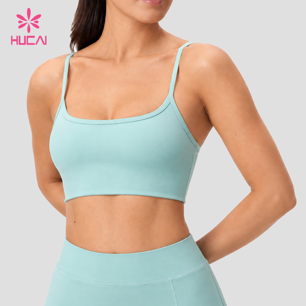 Custom light teal sports bra in the same construction showing the low-back U shape