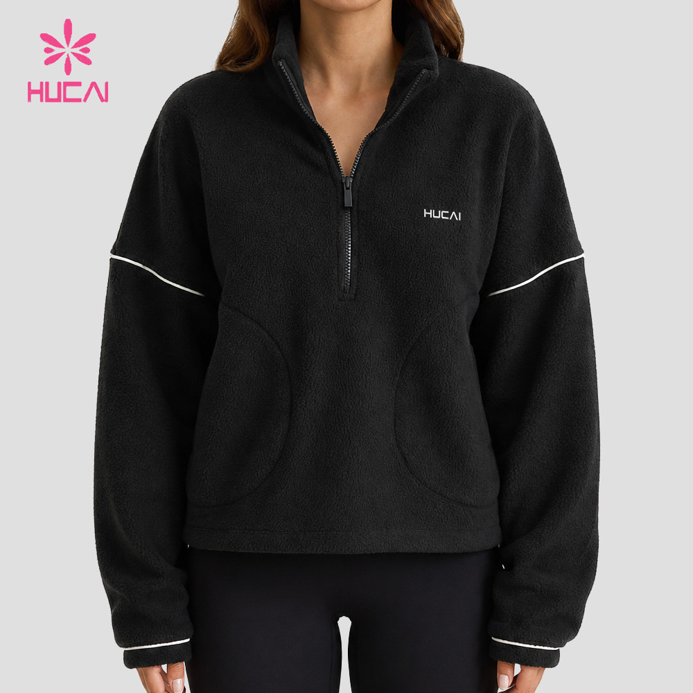 Full front view of the black quarter-zip fleece jacket with ivory contrast piping